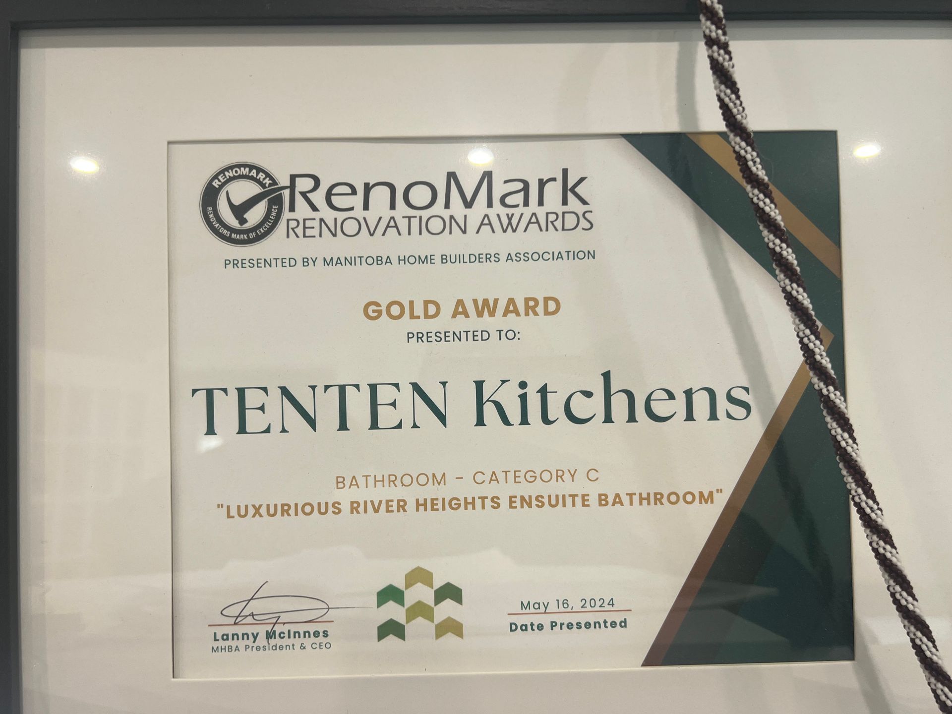 A framed RenoMark Gold Award presented to TENTEN Kitchens for the