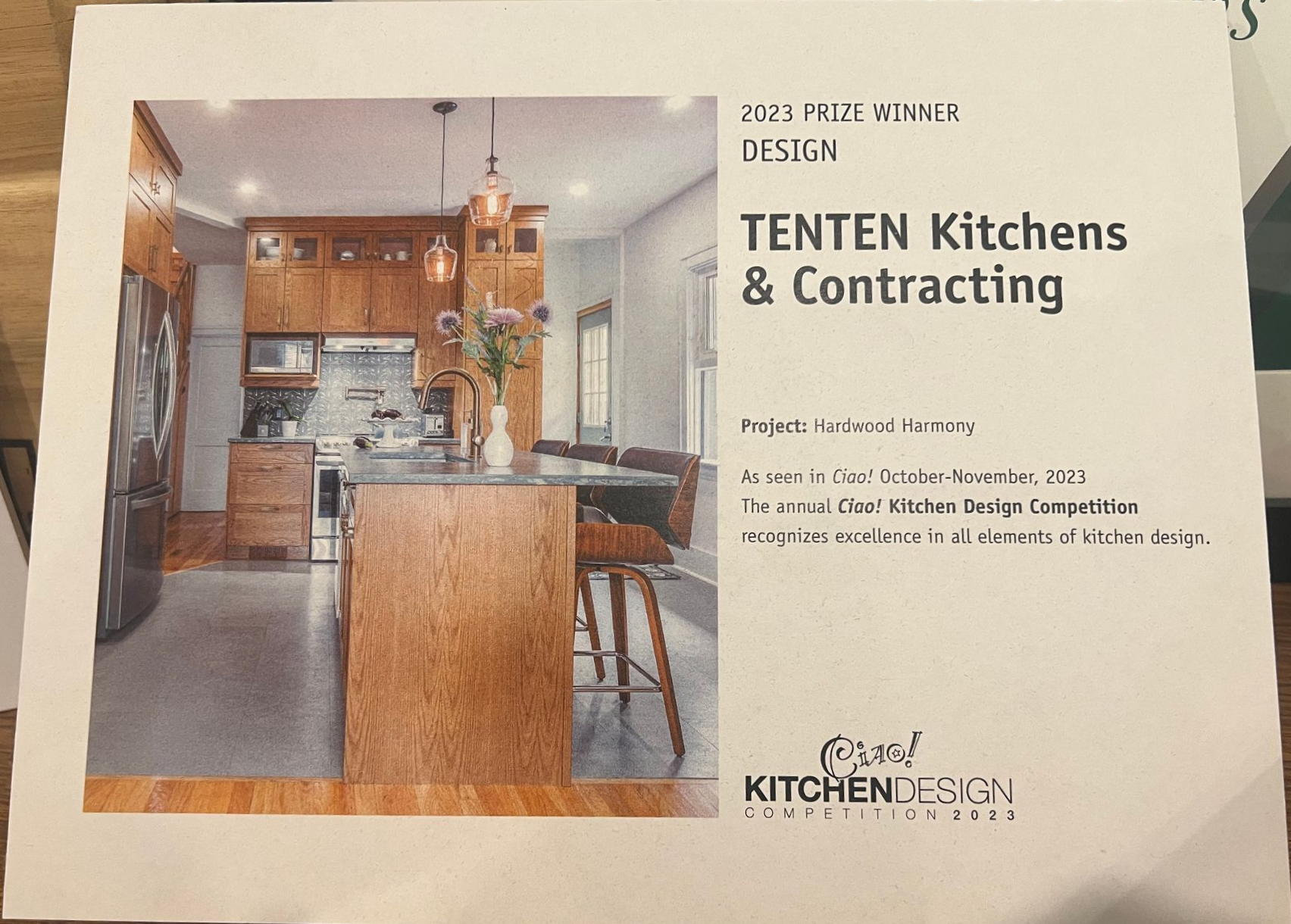 A promotional flyer for TENTEN Kitchens & Contracting featuring a photograph of a wood-toned kitchen with an island.