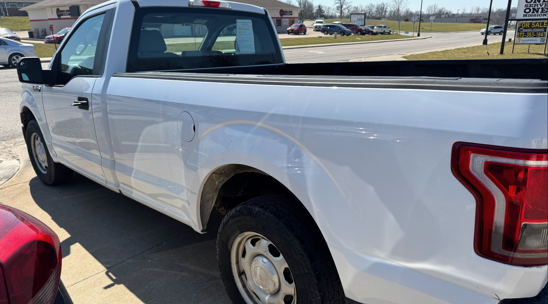 A 2016 white Ford F150 truck