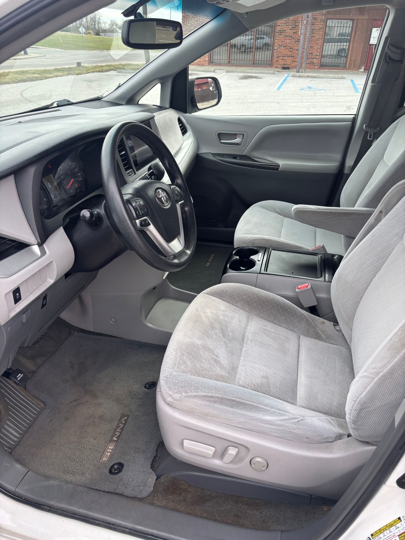 A white 2016 Toyota Sienna van