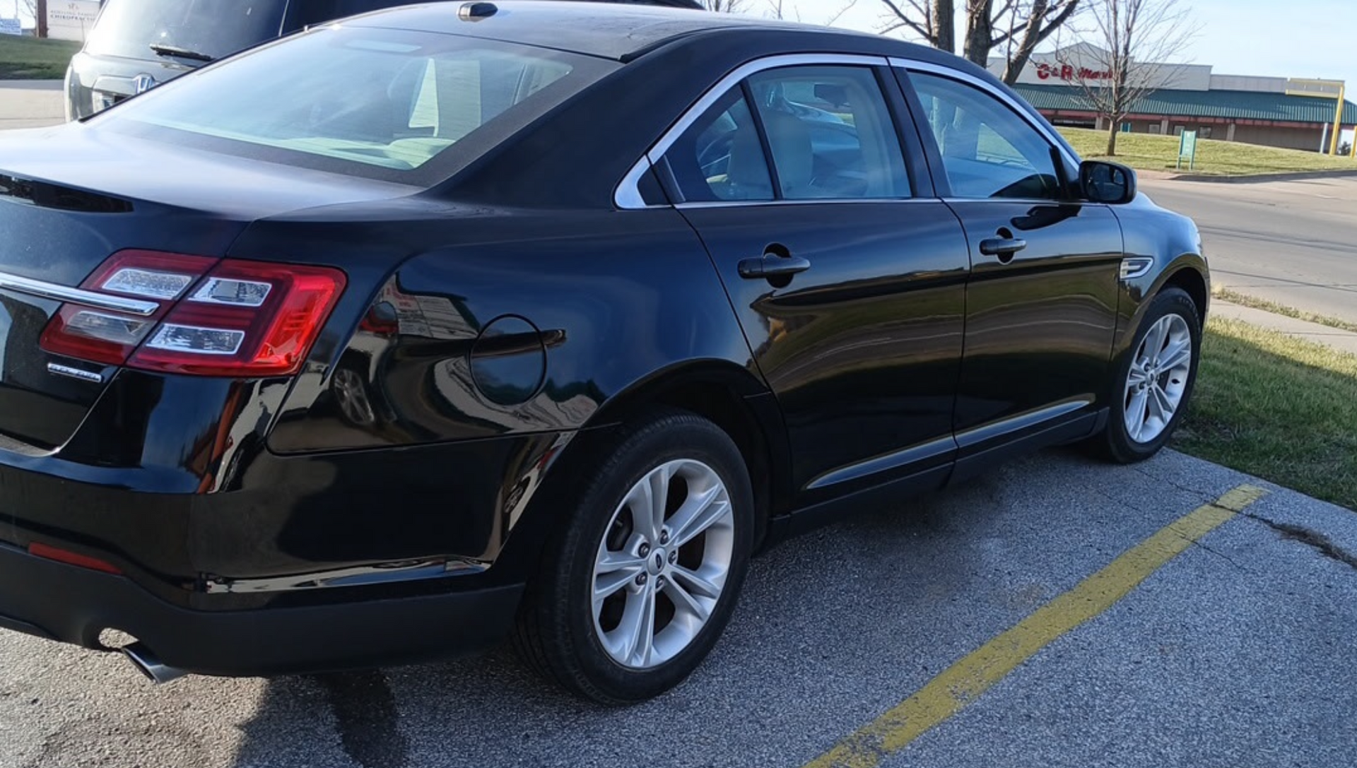 A flyer for a 2018 black Ford Taurus