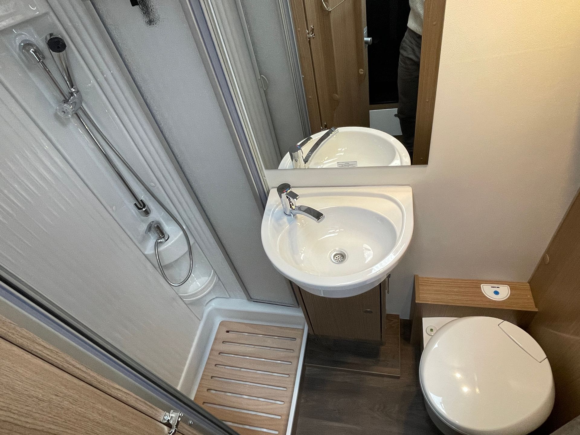 A bathroom with a sink , toilet and shower.