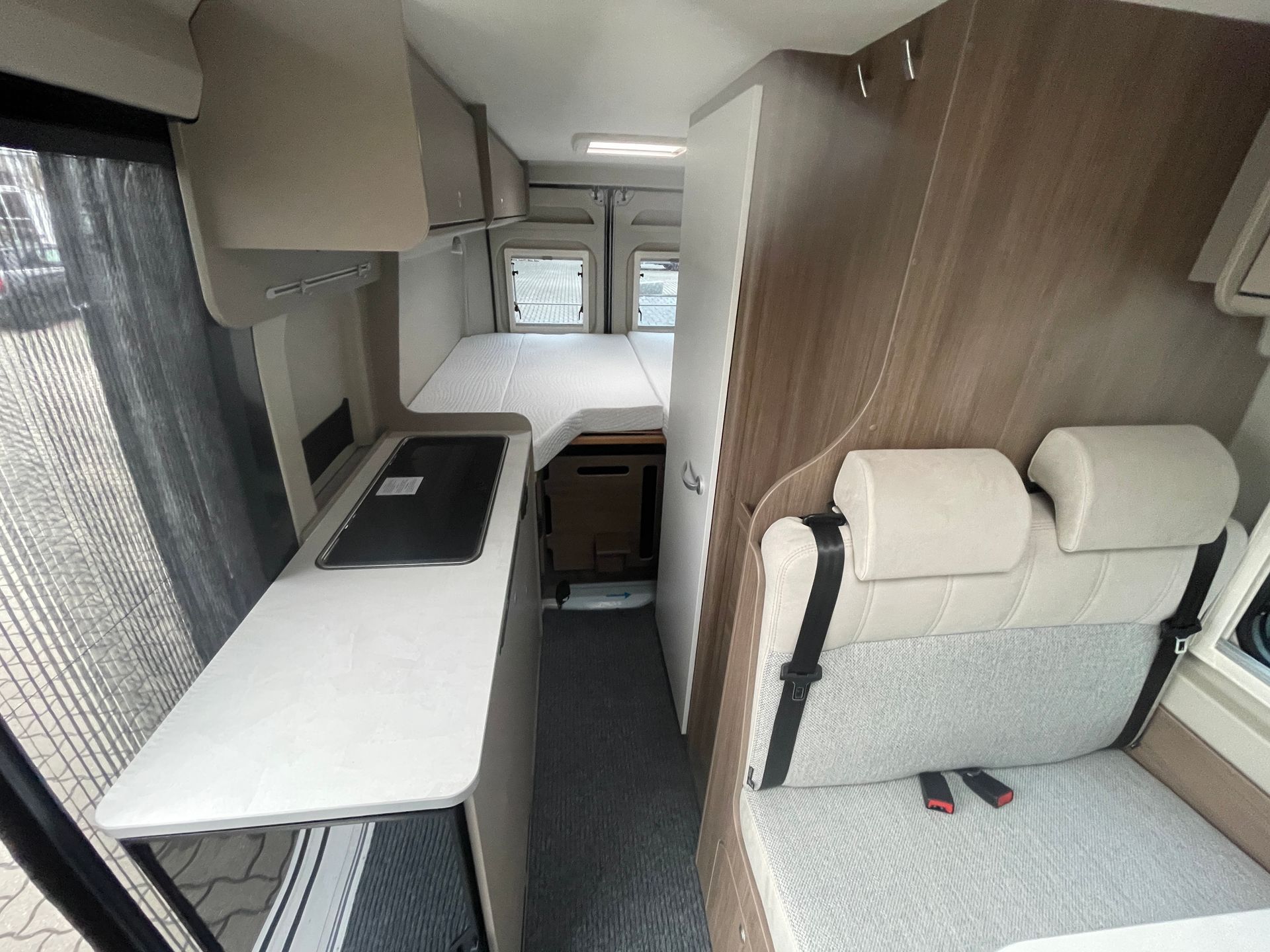 Das Innere eines Wohnmobils mit Bett und Küche.