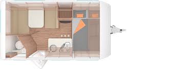 A floor plan of a camper trailer with a bed , toilet , and kitchen.