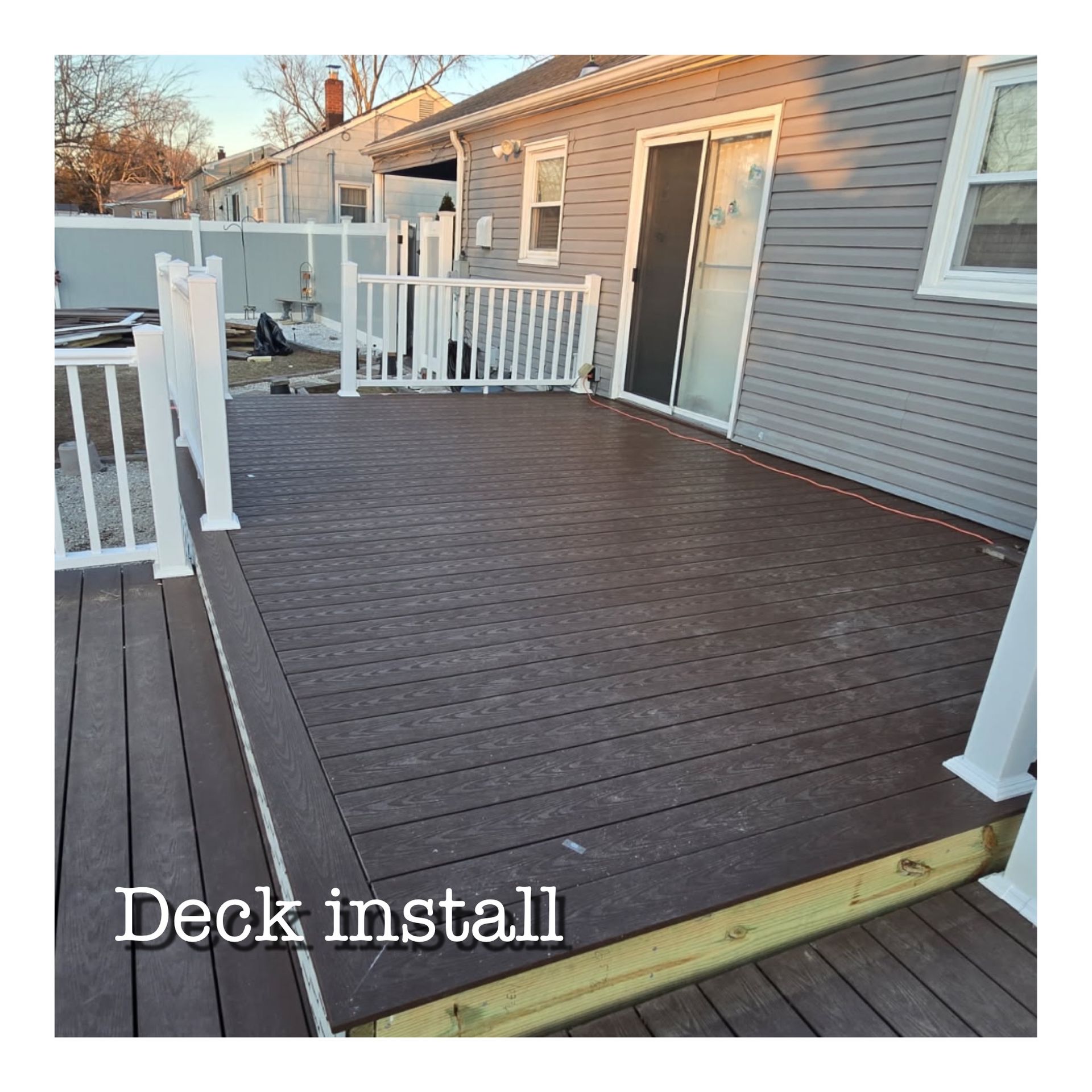 A picture of a deck being installed in front of a house.