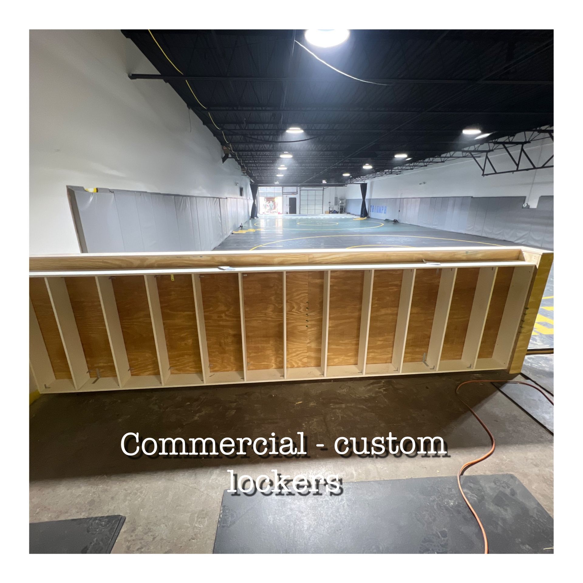 A large wooden box in a warehouse that says commercial custom lockers