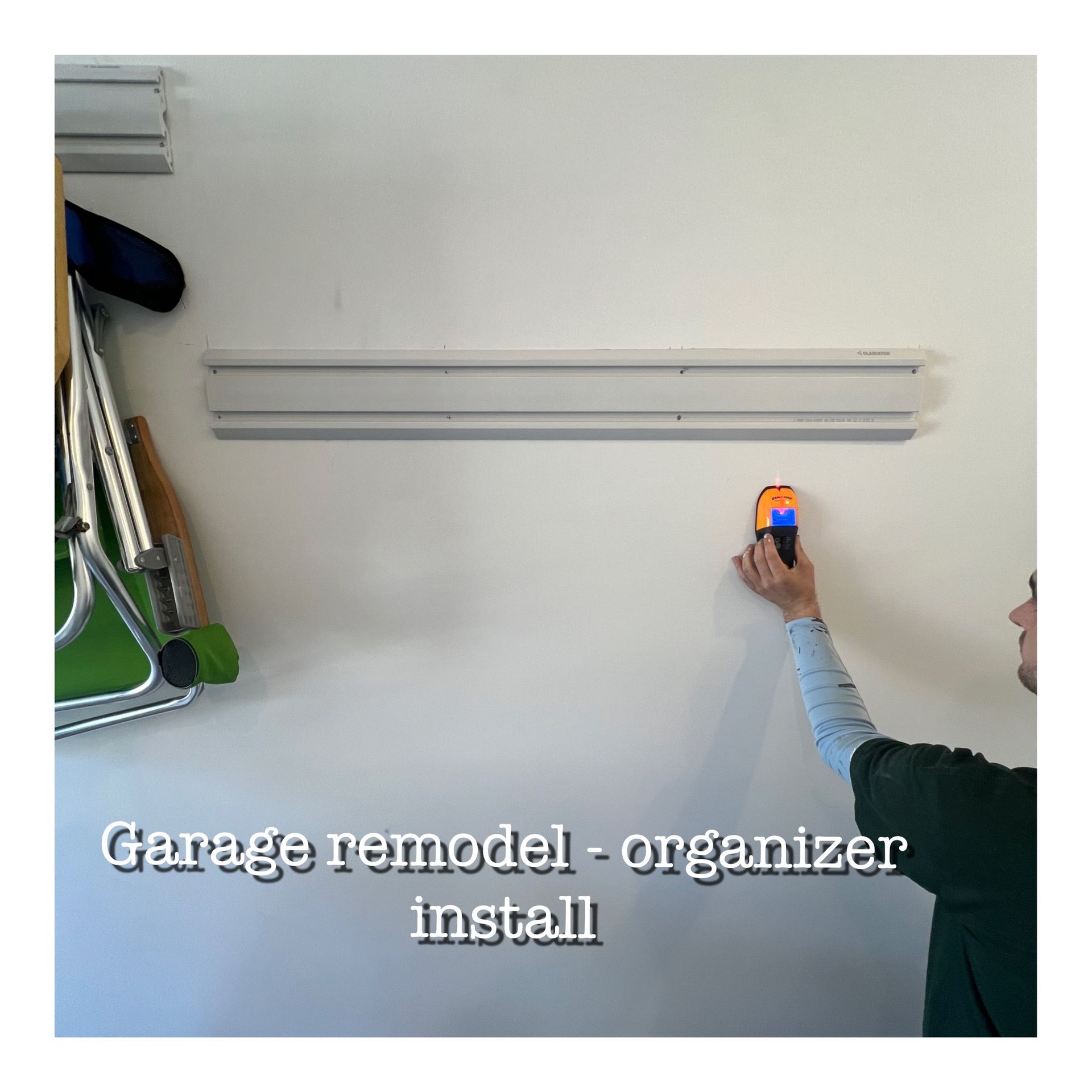 A man is installing a garage remodel organizer on a wall.