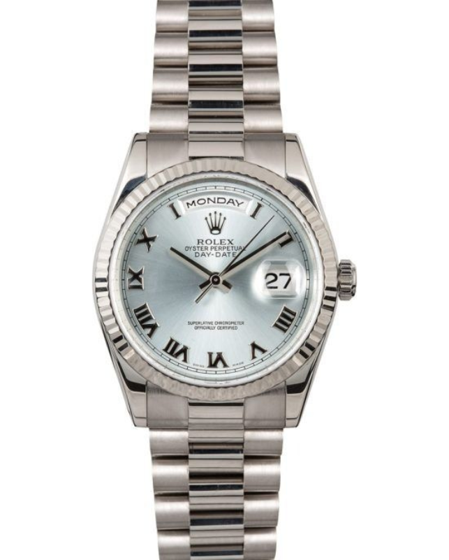 Silver Rolex watch with white dial and Roman numerals, showing Monday and date 27