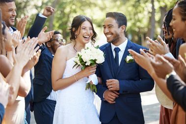Newly Wed Couple Surrounded by Friends at Wedding