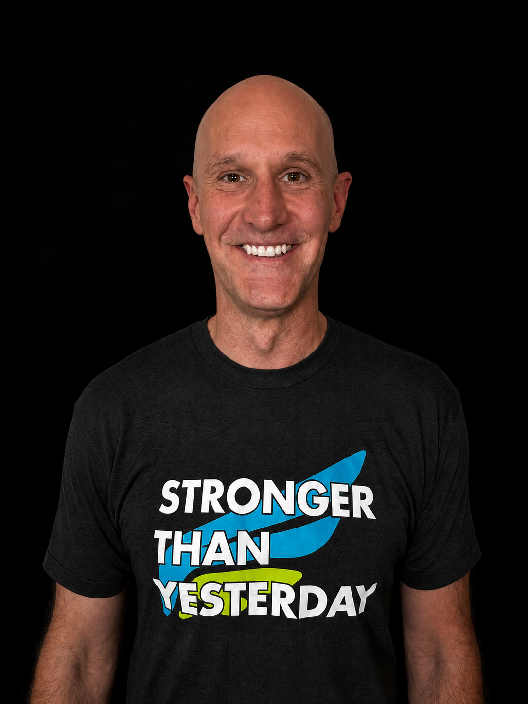 Smiling person in a dark tank top with “Stronger Than Yesterday” text on a black background