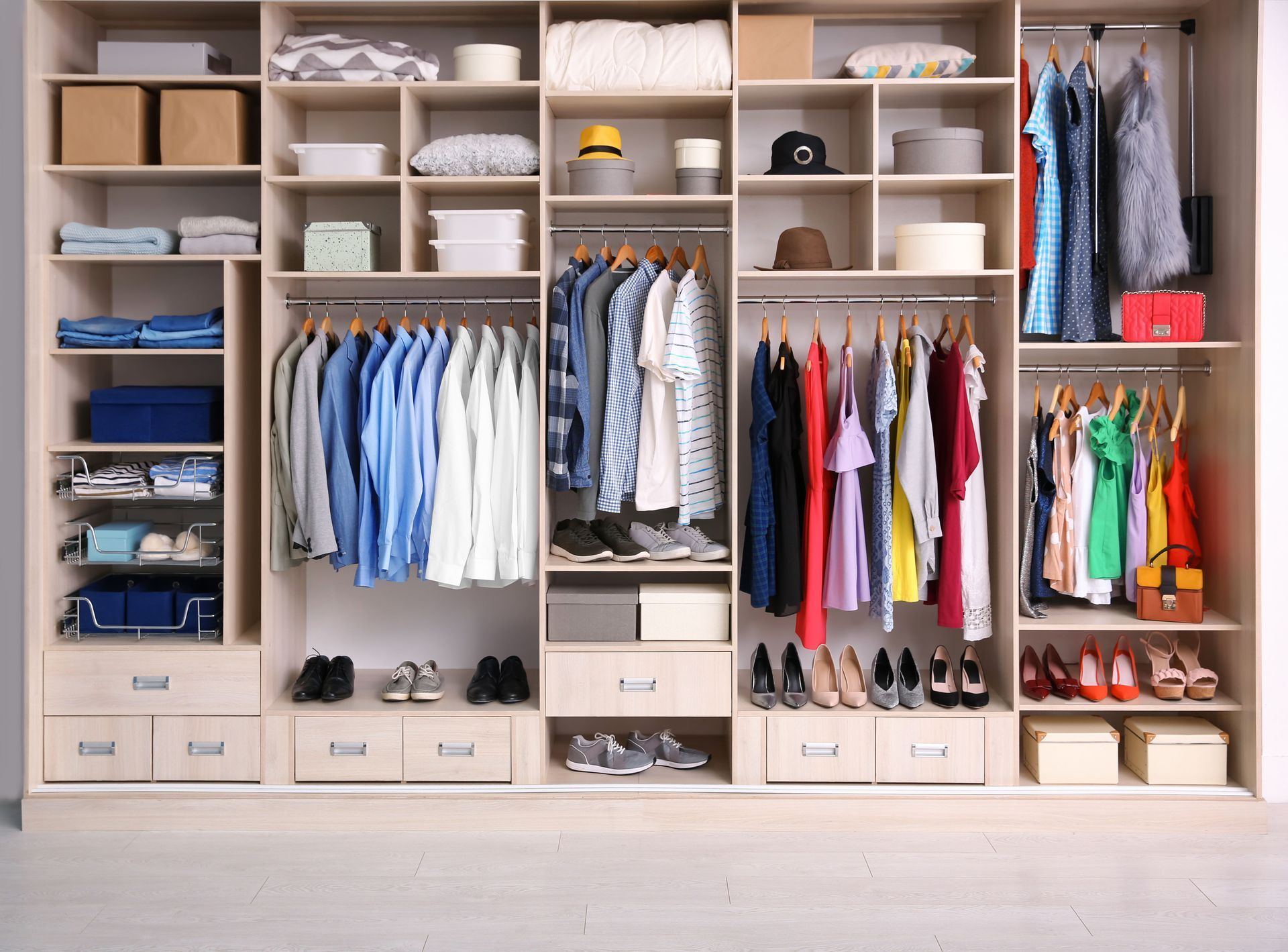 A large closet filled with lots of clothes and shoes.