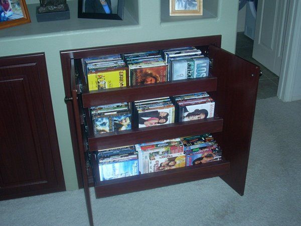 A shelf full of dvds including one that says ' i love you ' on it