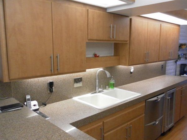 A kitchen with stainless steel appliances and wooden cabinets