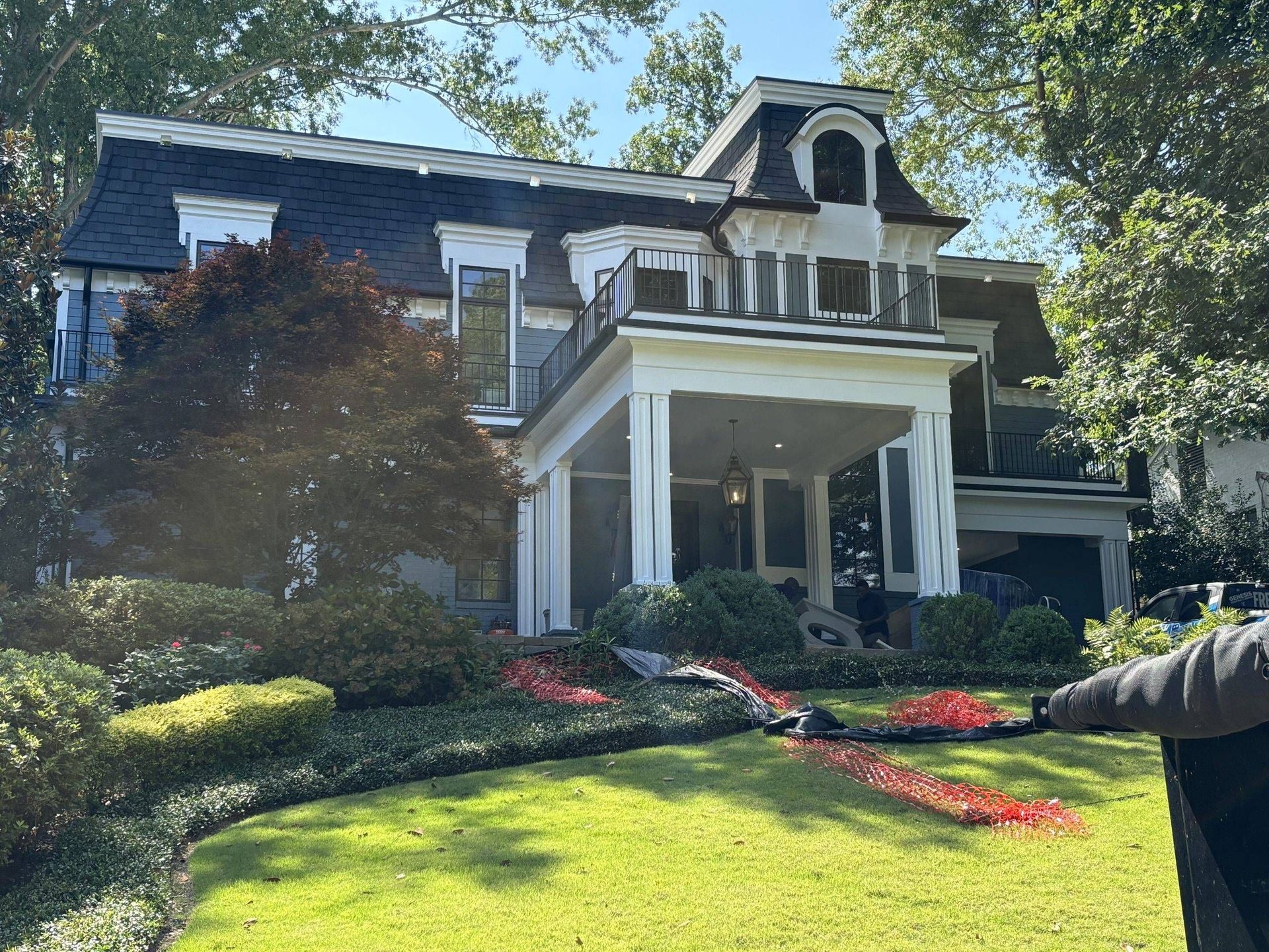 Professional roofing team of Genesis roofing and repair performing emergency roof repair on a storm-damaged home in Lawrenceville, GA.