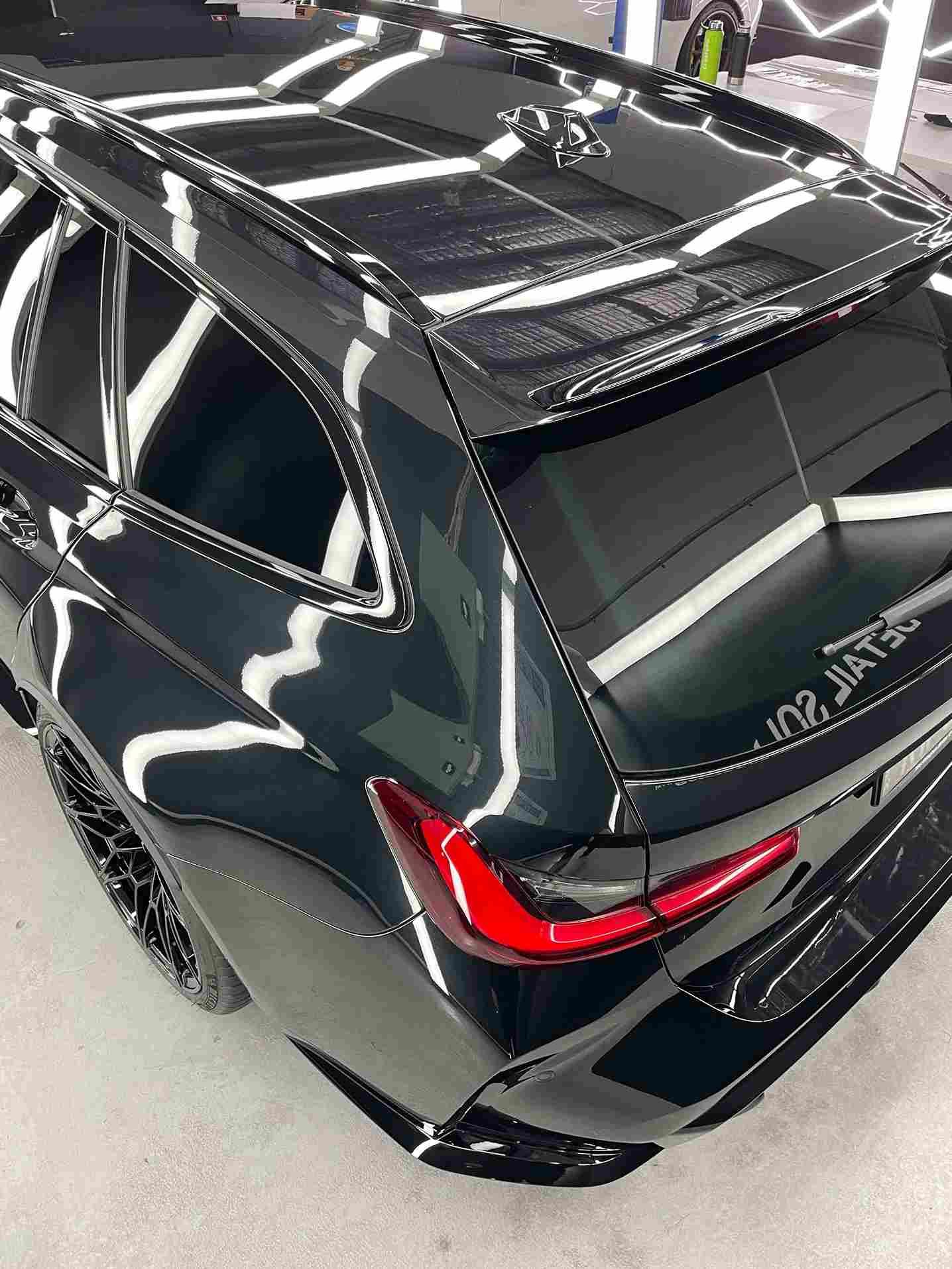 Black BMW station wagon with glossy finish.