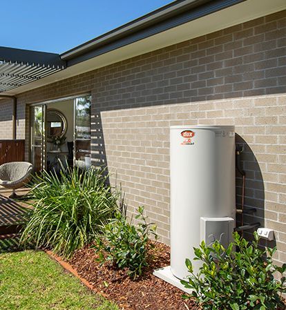 Outdoor Hvac Unit Beside a Brick House Wall — Forster Hotwater in Taree, NSW