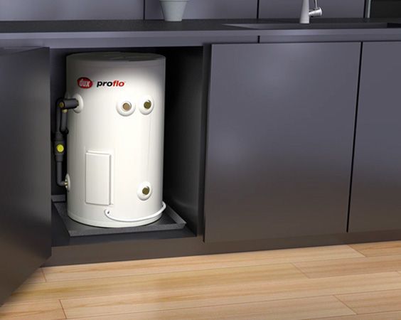White Water Heater in a Dark Cabinet Under a Counter — Forster Hotwater in Smiths Lake, NSW