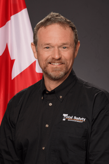 A man wearing a black shirt with the word safety on it