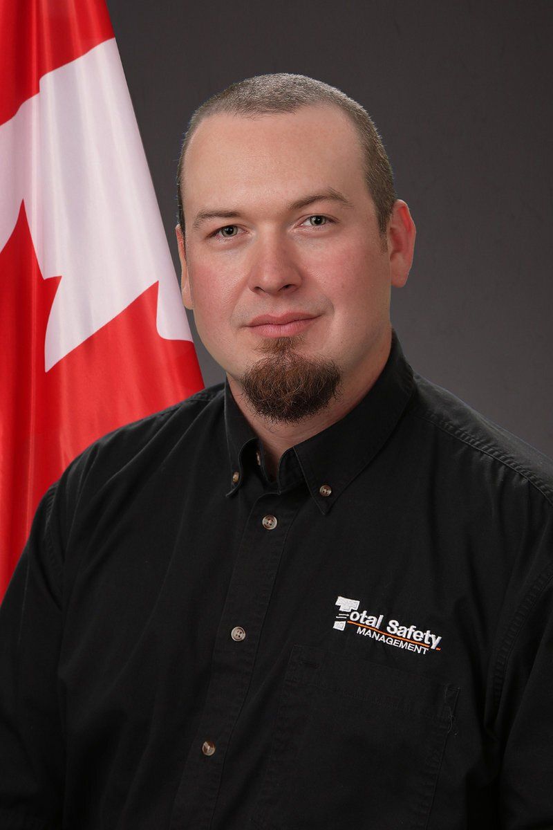 A man standing in front of a canadian flag