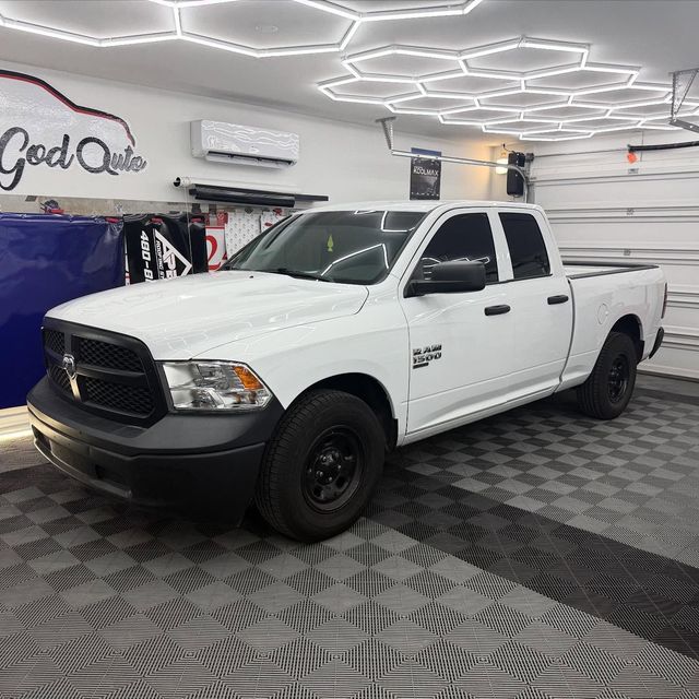 White Dodge Ram pickup truck in a garage with hexagon lights.