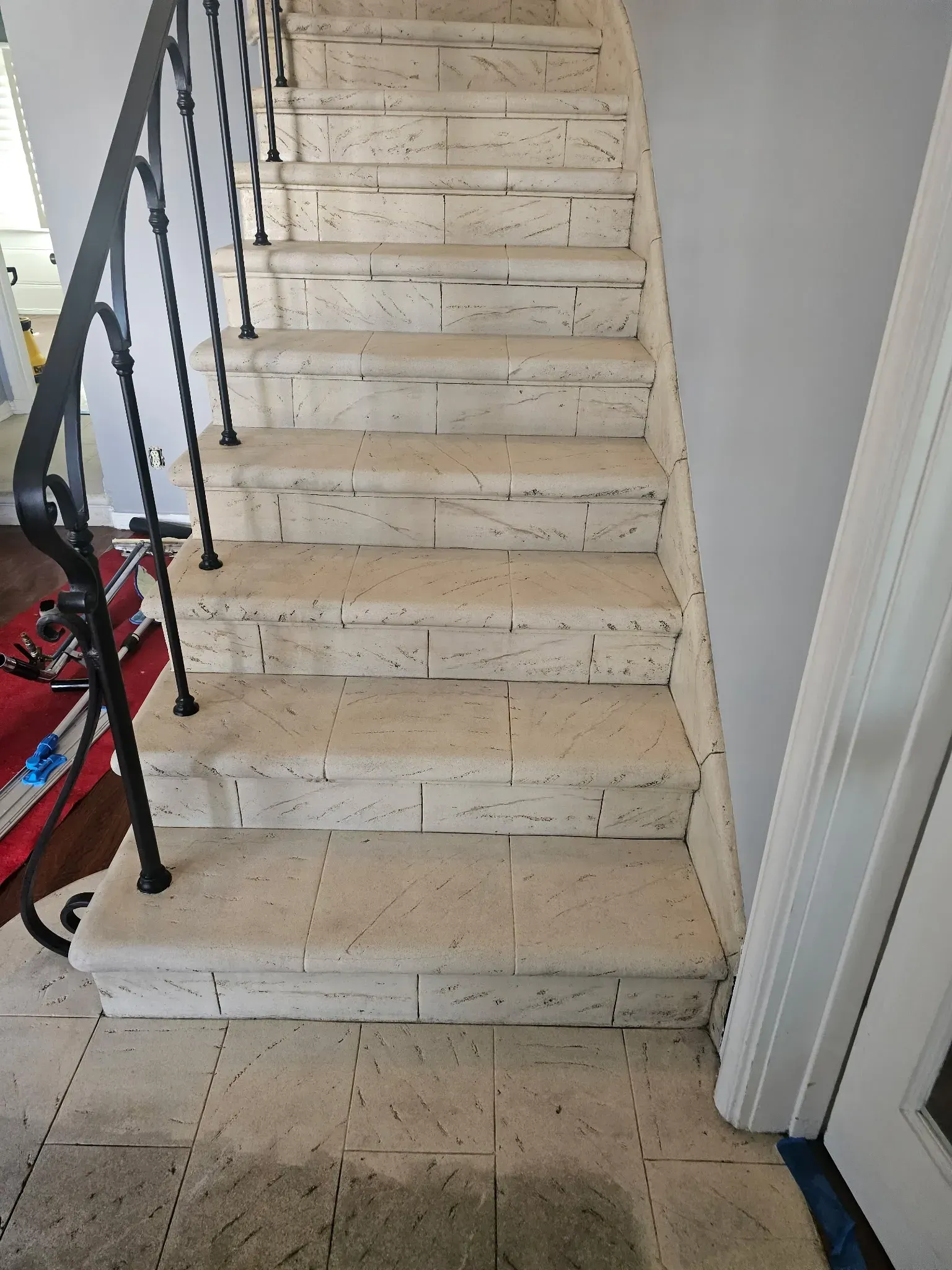 A person is cleaning a marble floor with a machine.