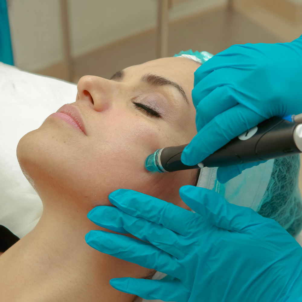 A professional wearing pink gloves uses a small syringe to administer a cosmetic injection near a smiling person's eye.