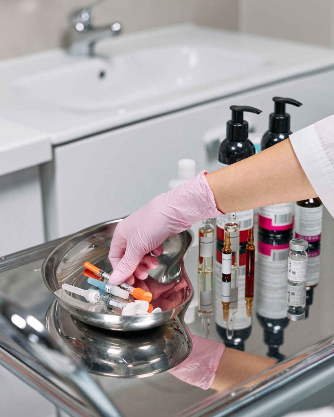 A practitioner in a white coat uses a suction cupping device on a person’s back in a bright, modern spa room.