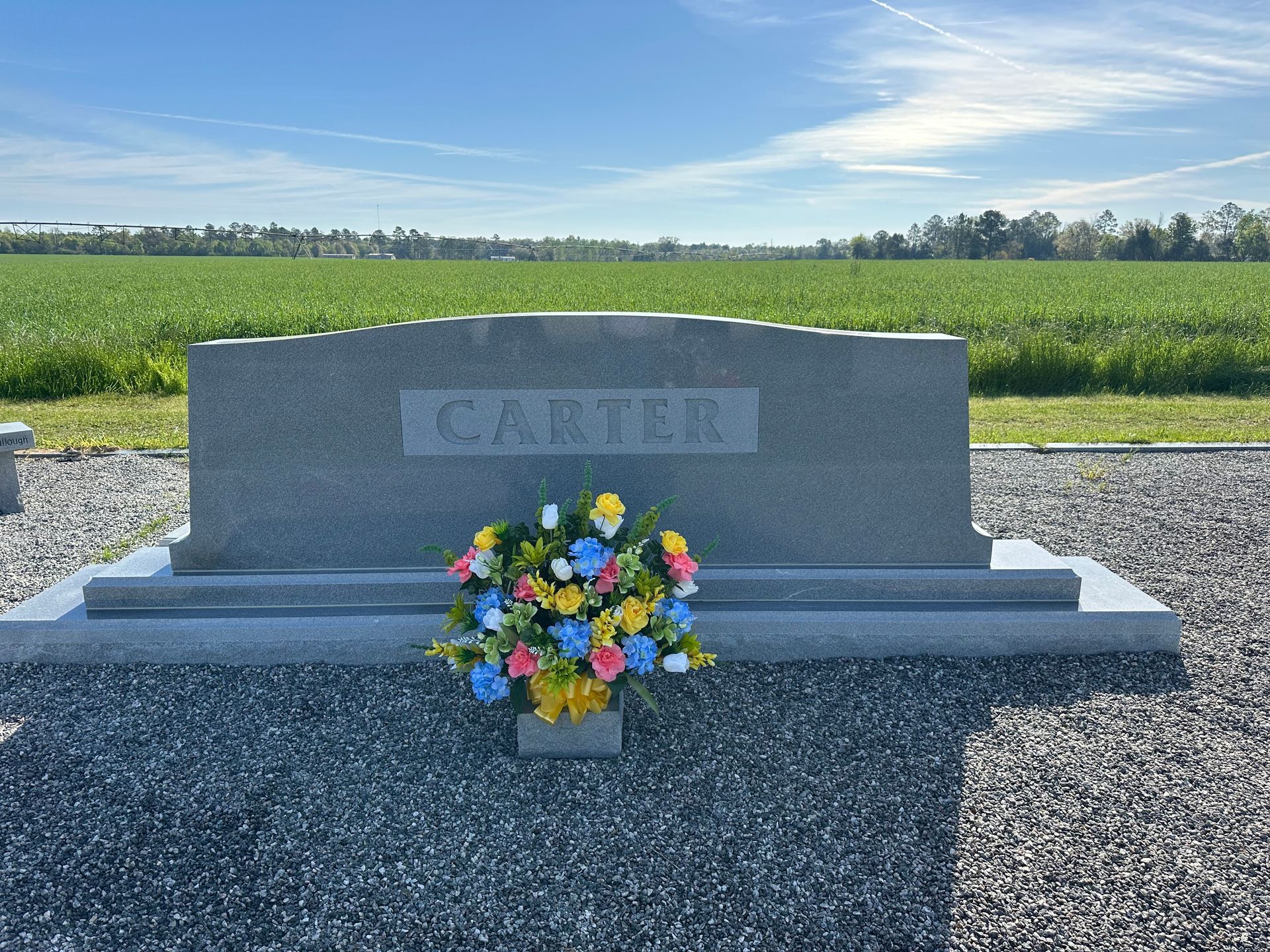 A gravestone for the lions building in a grassy field