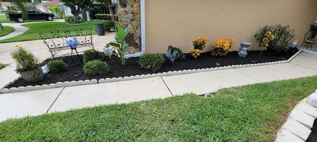 A person is digging a hole in the grass with a shovel.