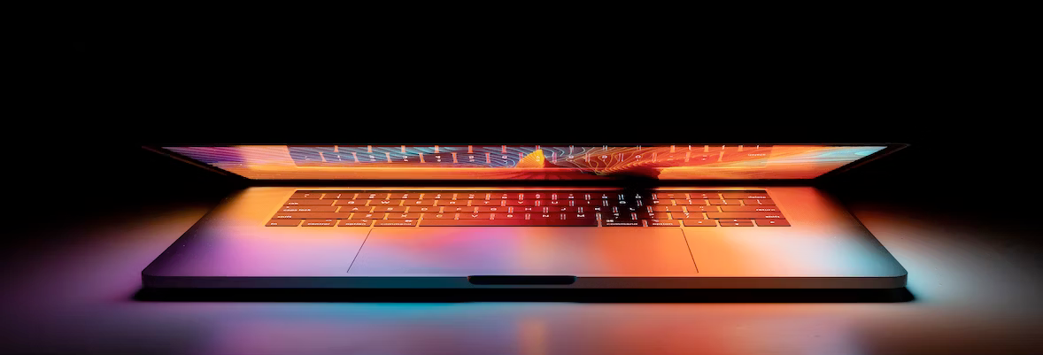 A laptop computer is open and sitting on a table.