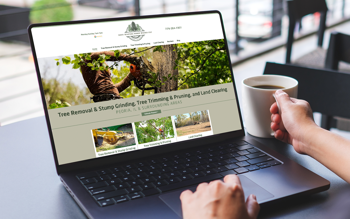 A person sitting at a table with a coffee cup, viewing a nature-themed website on a laptop screen.