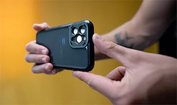 A person is holding a cell phone in their hands.