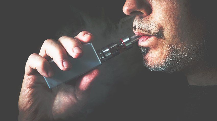 A man smoking from a vape