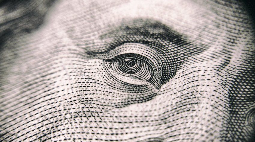 A close up of a dollar bill showing the eye.