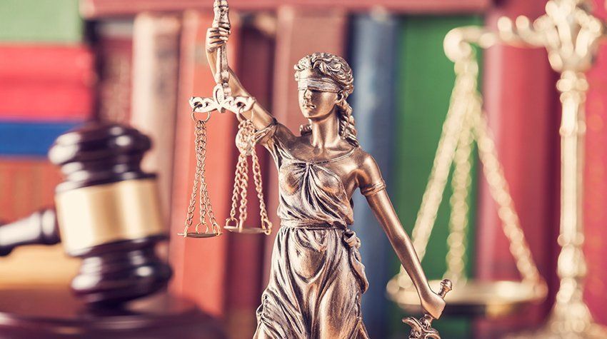 A statue of justice holding a scale and a gavel.