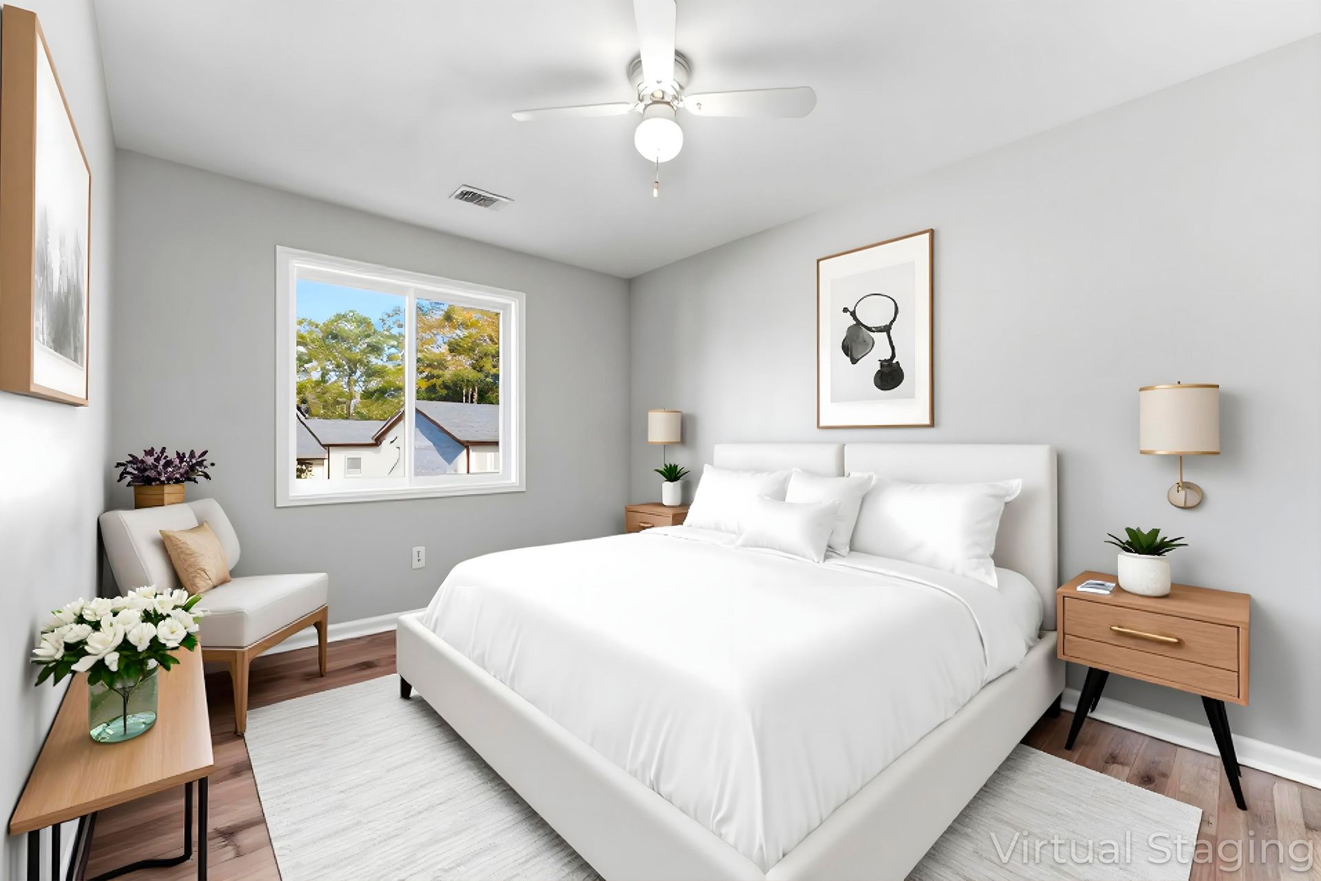 Bright bedroom with white bed, gray walls, and natural light from a window