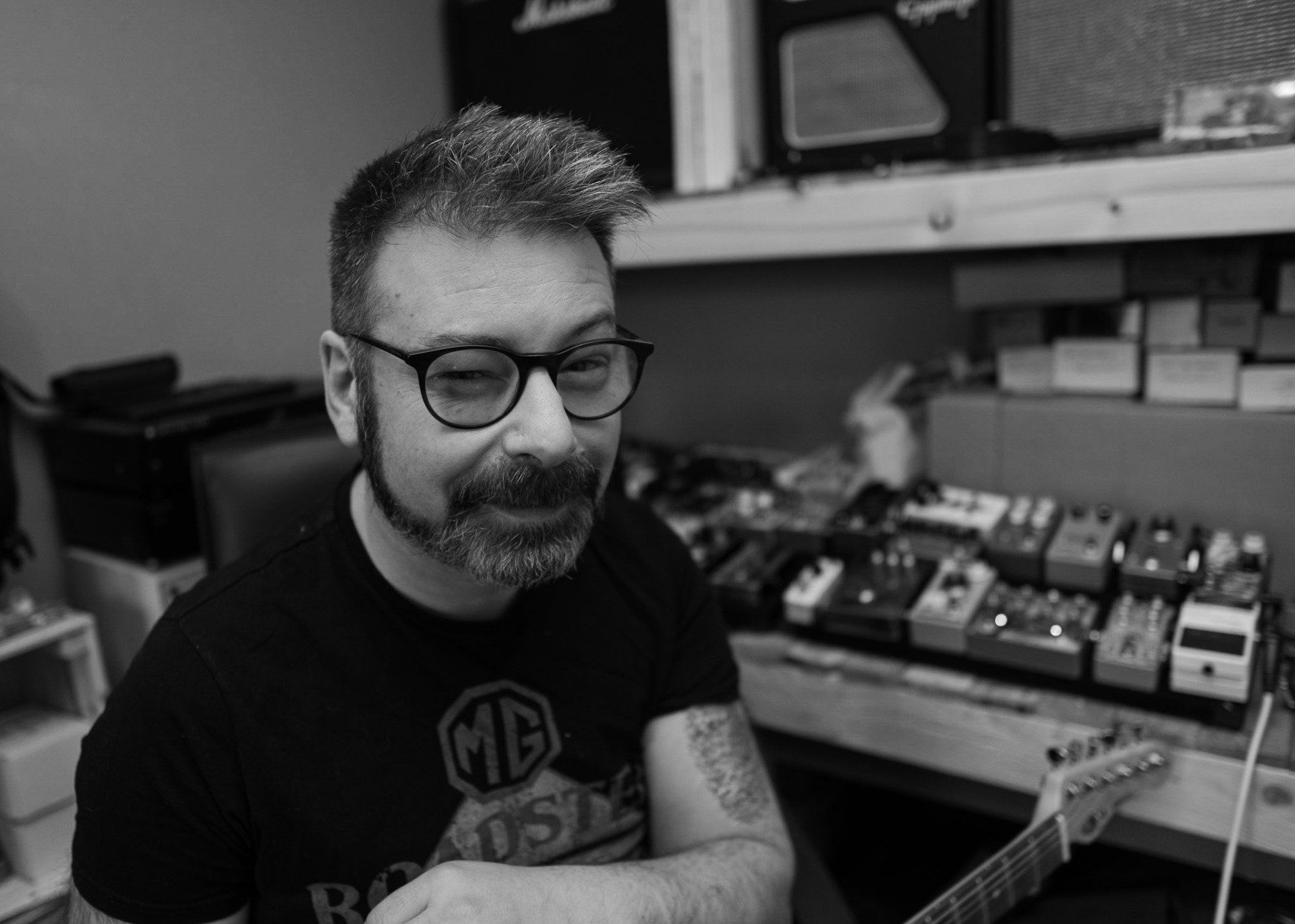 man with beard and glasses winking