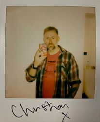 christian savil holding guitar effect pedal