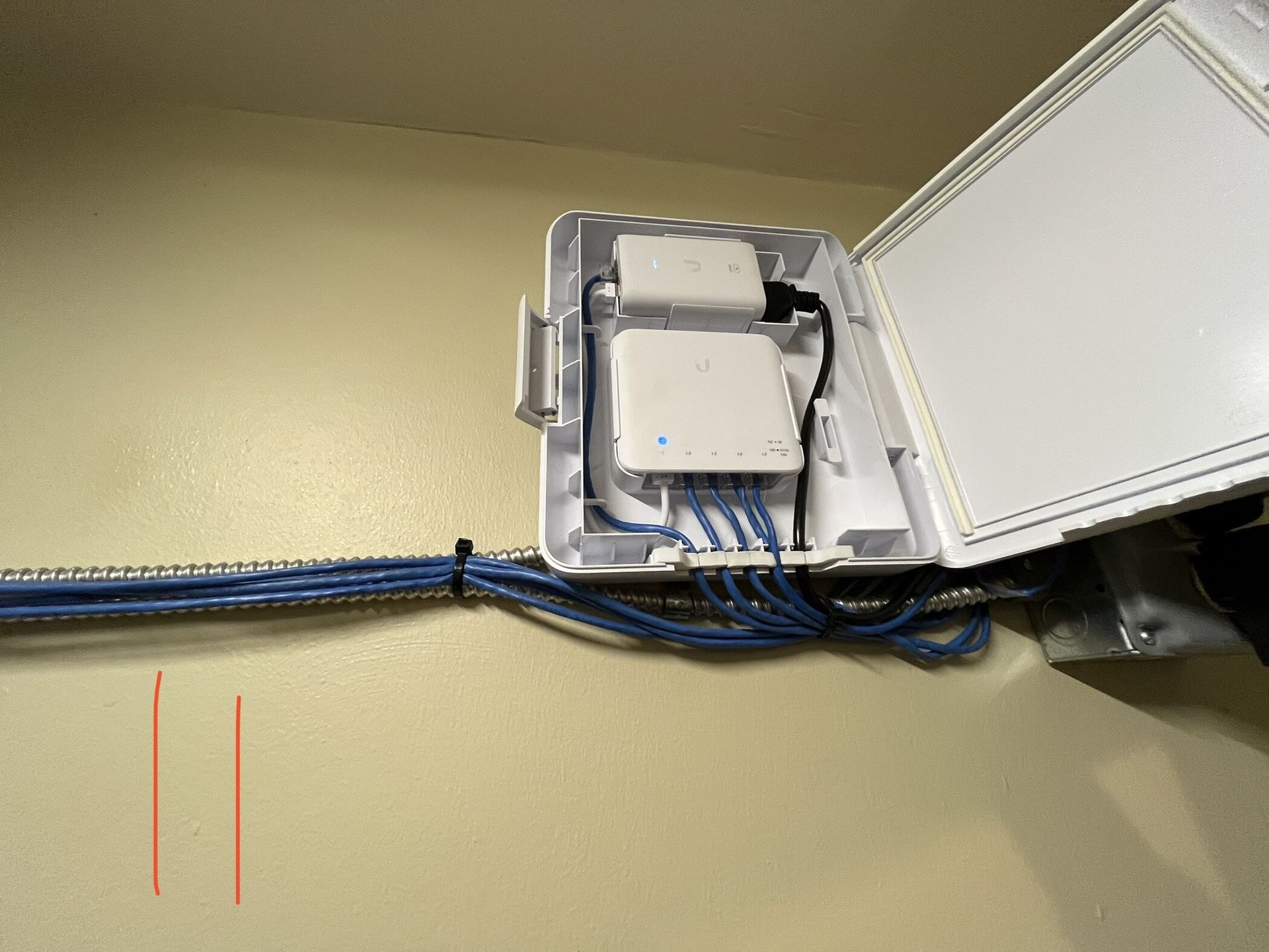 A white box with a bunch of wires coming out of it