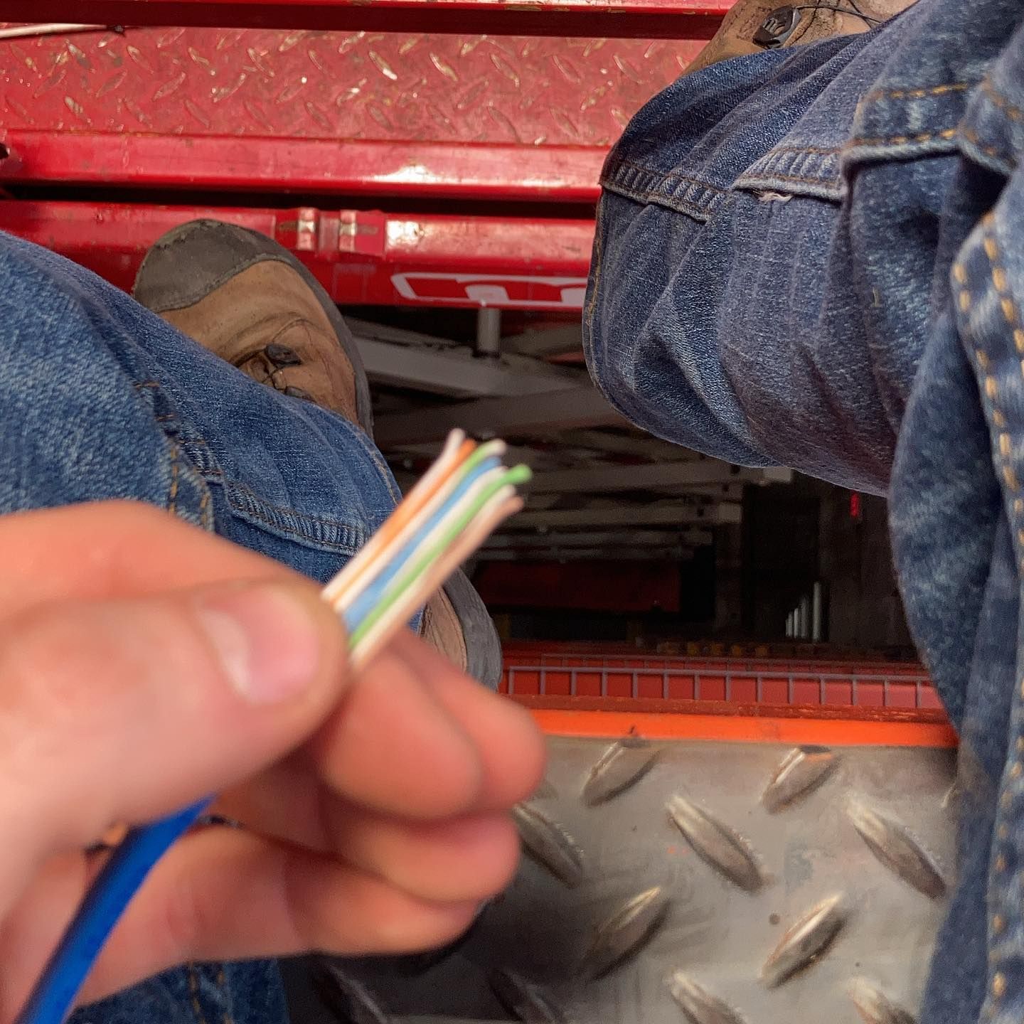 A person is holding a piece of wire in their hand