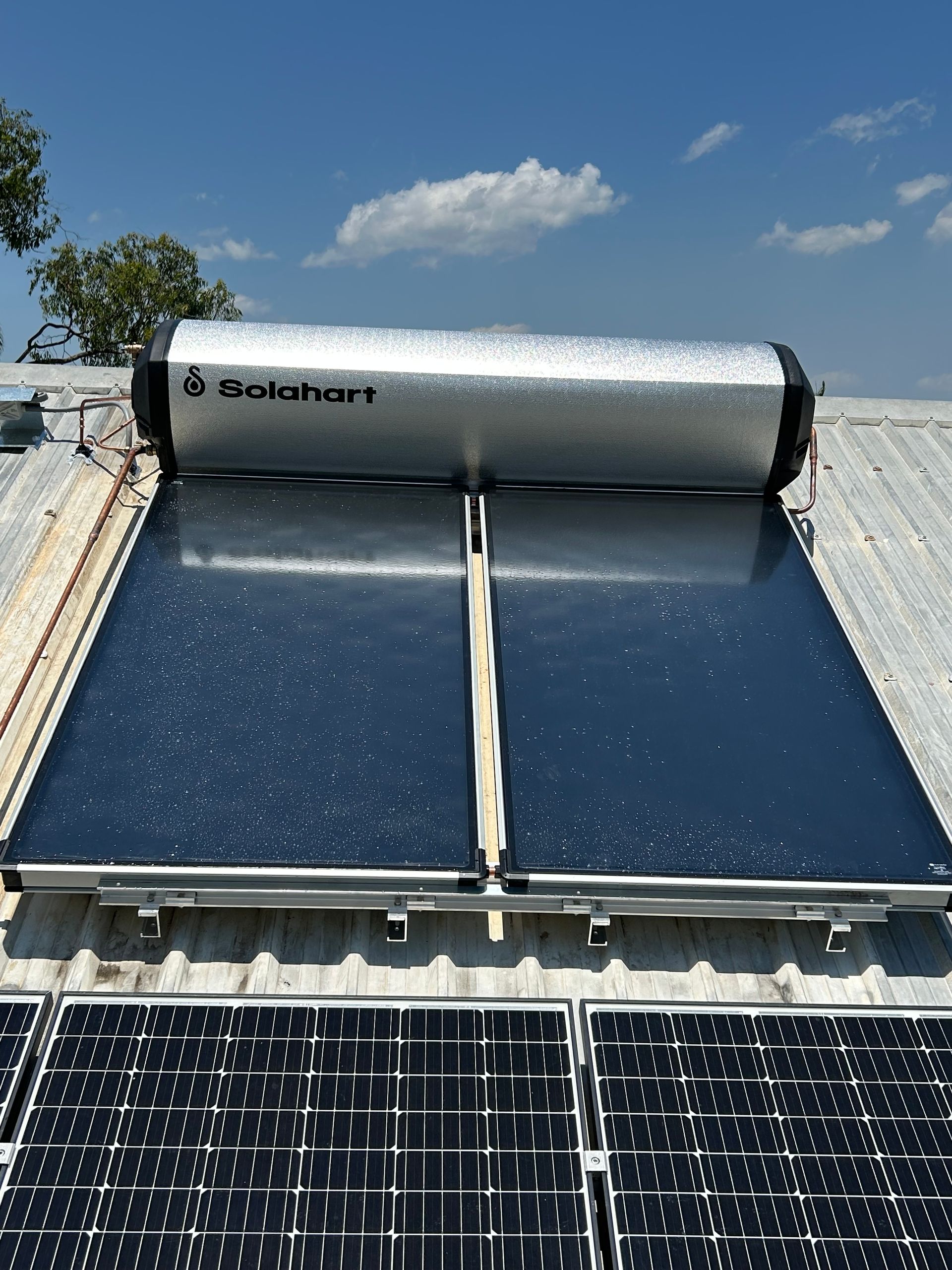 A Roof With a Water Heater and Solar Panels on It — Nightcliff Plumbing & Gas In Coconut Grove, NT