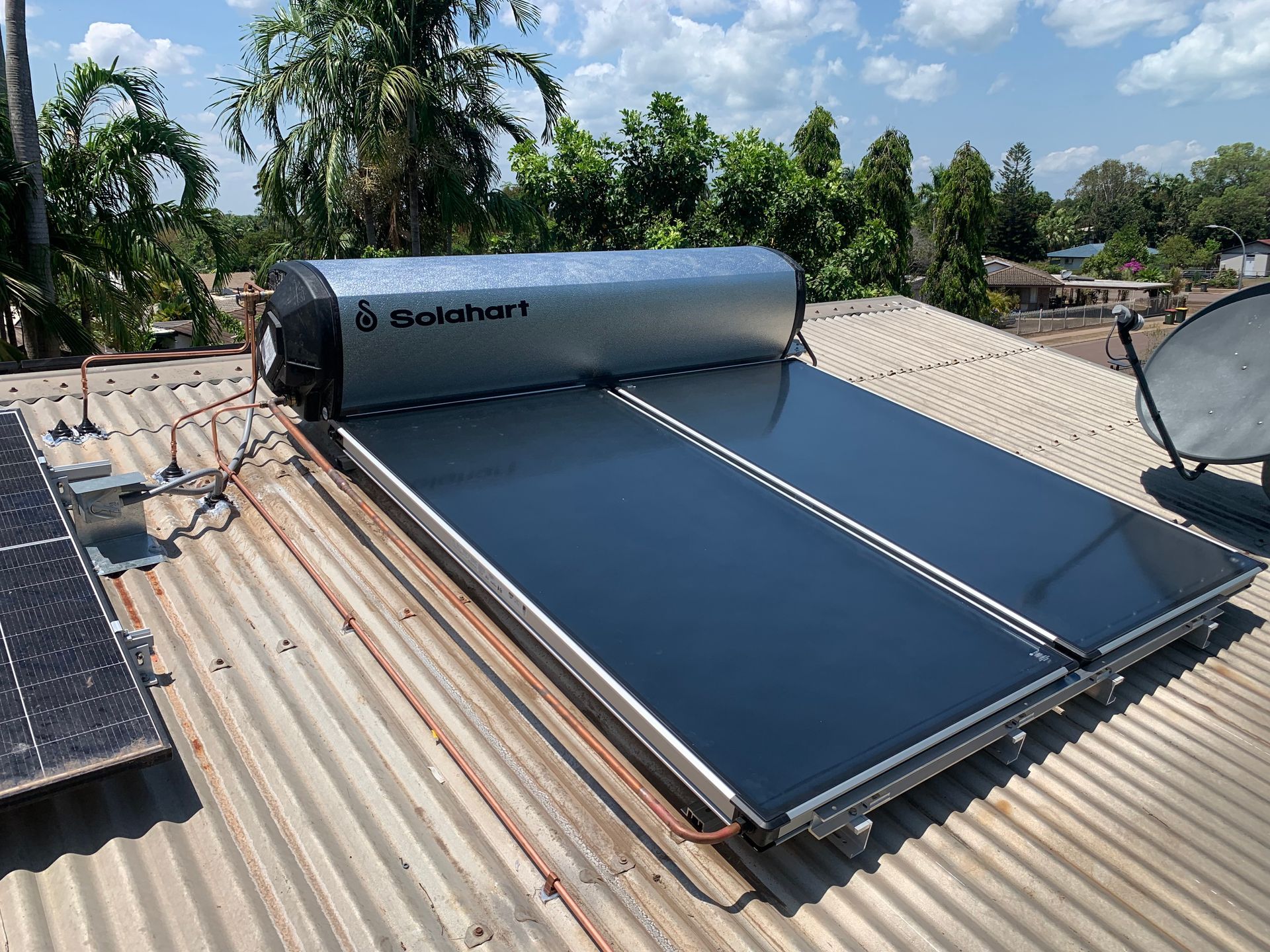 A Solar Powered Water Heater is Mounted on the Roof of a Building — Nightcliff Plumbing & Gas In Coconut Grove, NT