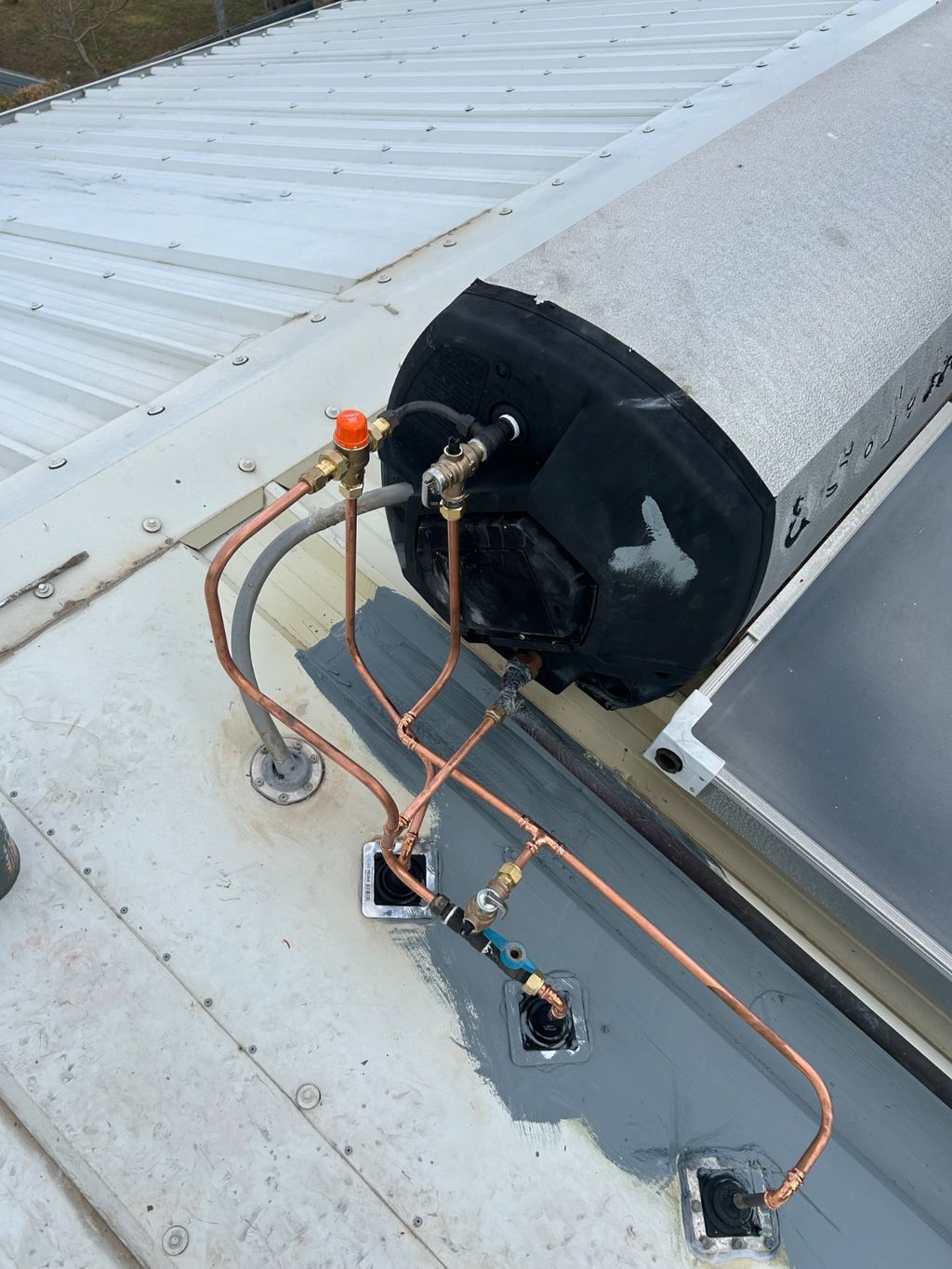 Wires and sensor devices mounted on a rooftop near a large black vent pipe — Nightcliff Plumbing & Gas In Coconut Grove, NT