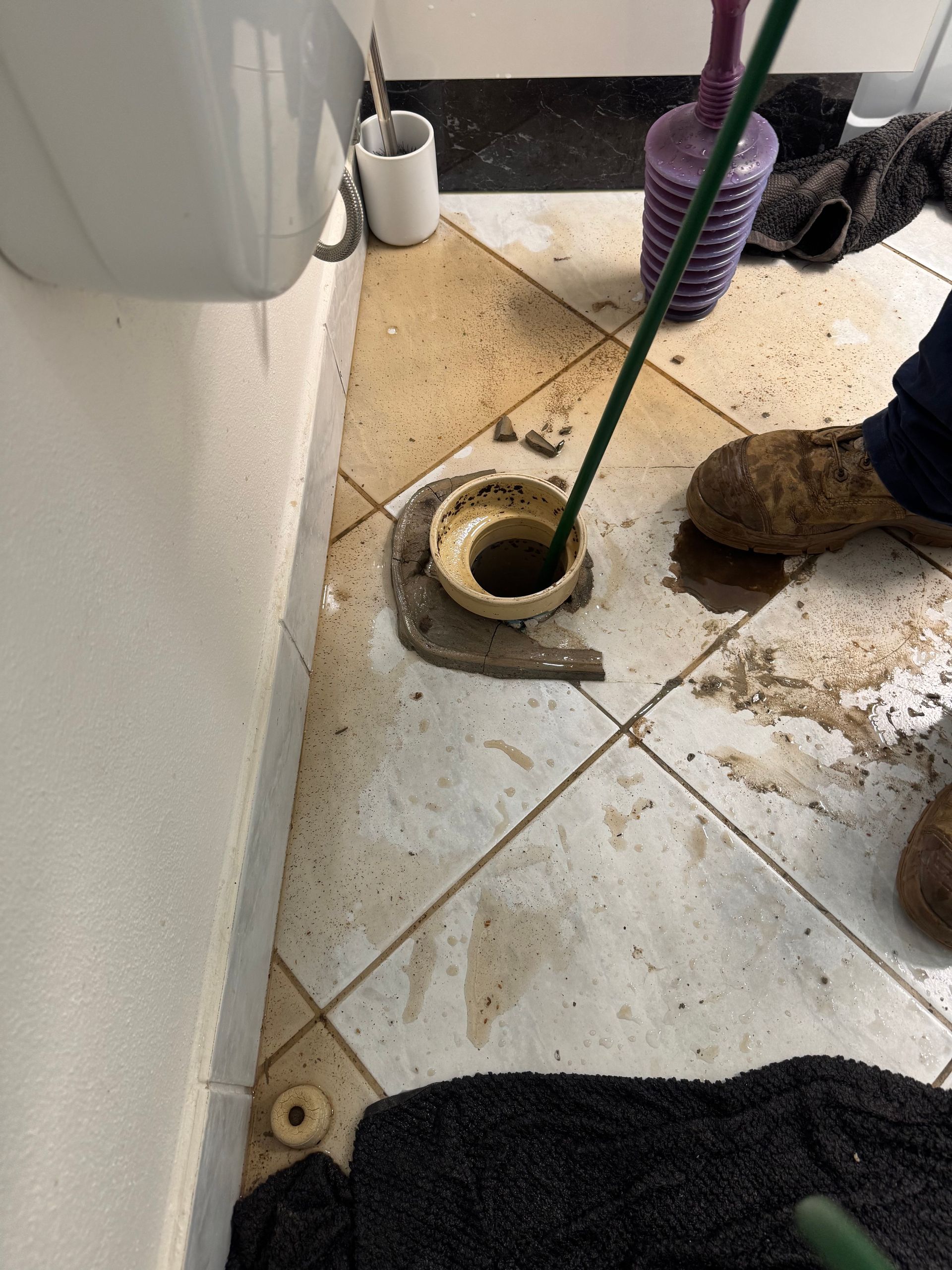 A Bathroom Sink With a Plunger and a Wrench in It — Nightcliff Plumbing & Gas In Coconut Grove, NT