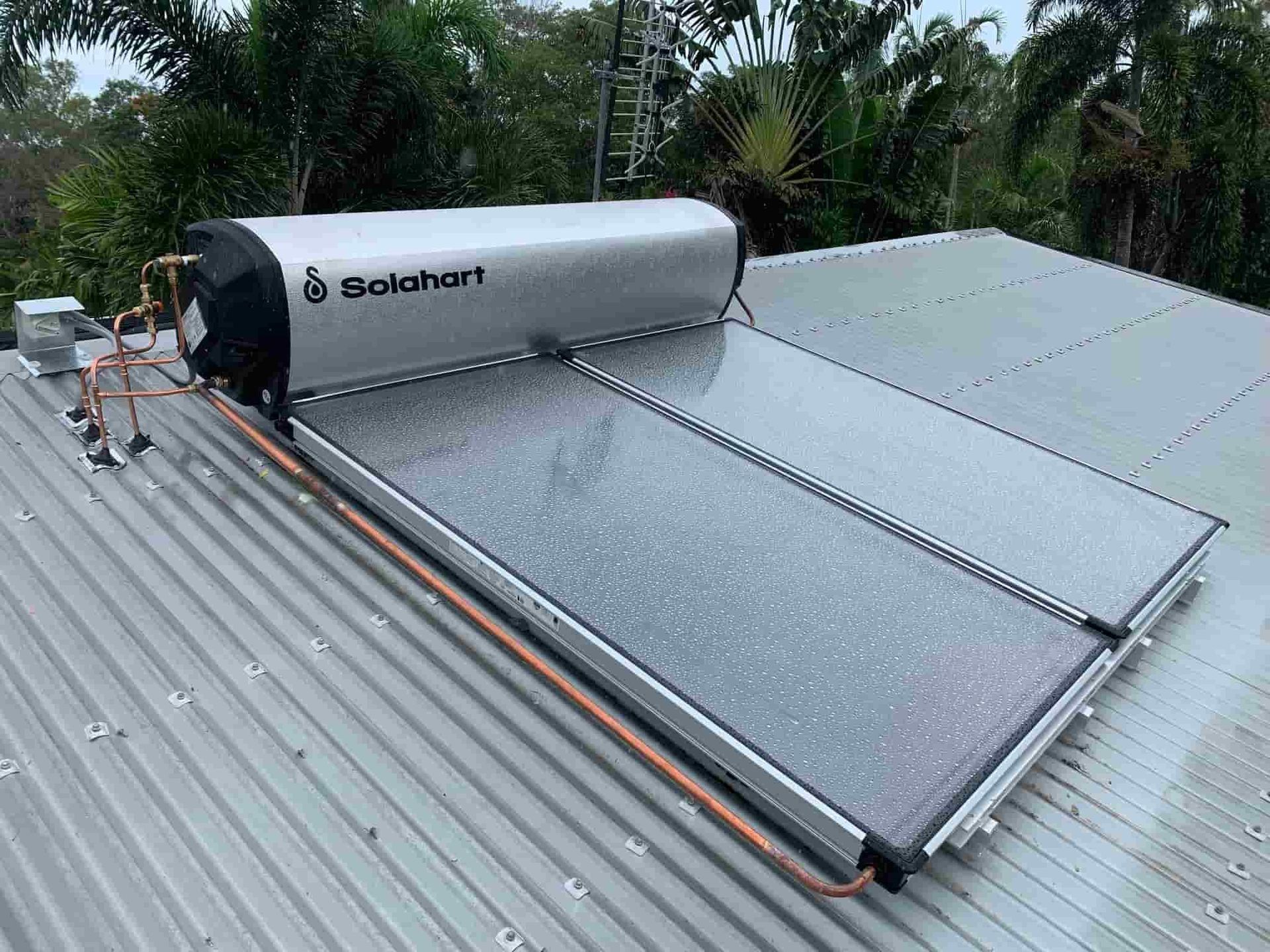 A Solar Water Heater is Sitting on Top of a Metal Roof — Nightcliff Plumbing & Gas In Coconut Grove, NT