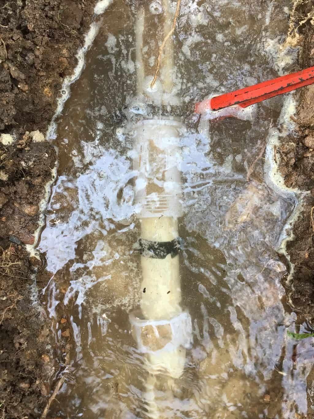 A Pipe is Sitting in a Puddle of Water — Nightcliff Plumbing & Gas In Coconut Grove, NT