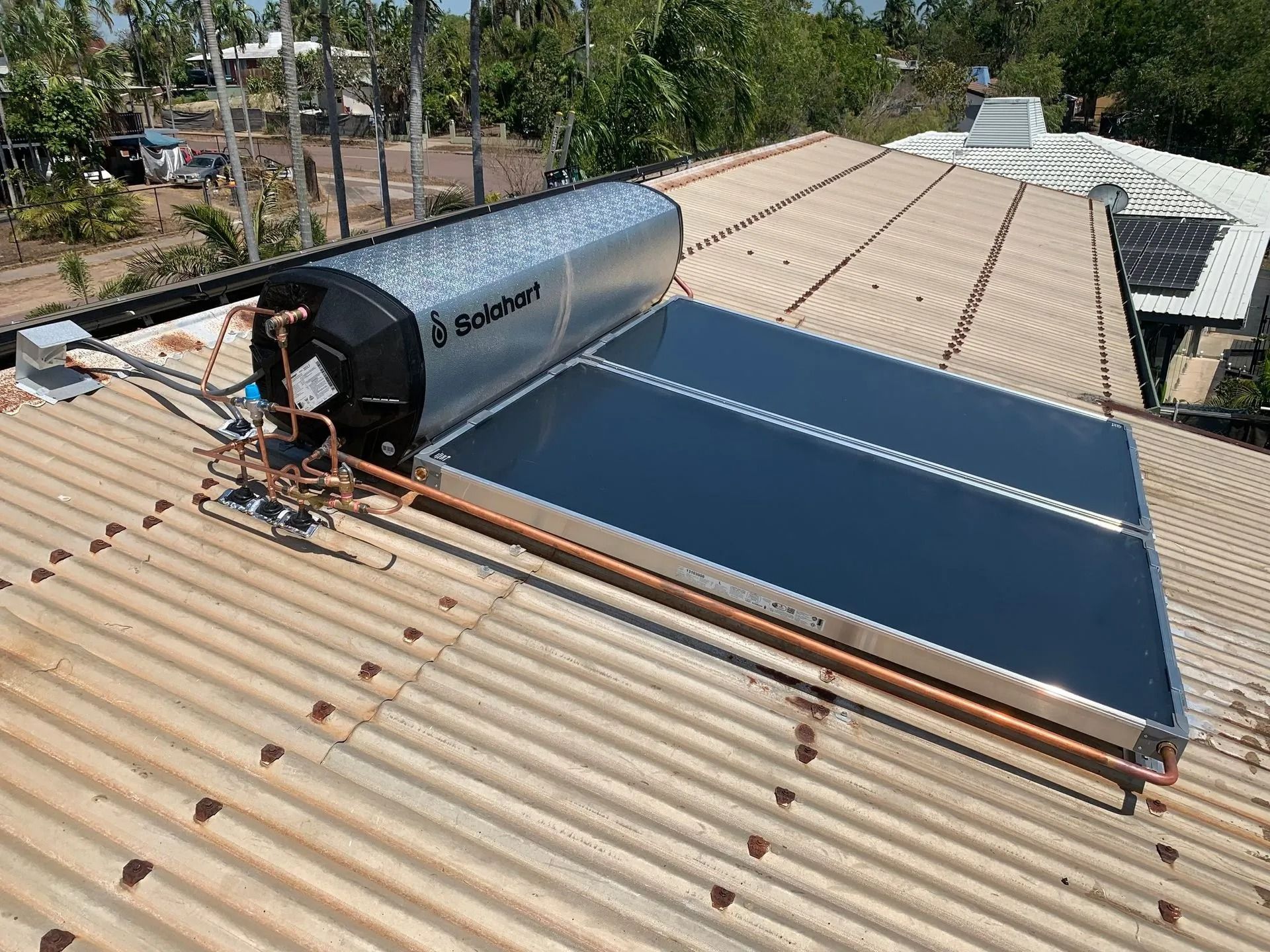A Solar Water Heater is Sitting on Top of a Roof — Nightcliff Plumbing & Gas In Coconut Grove, NT