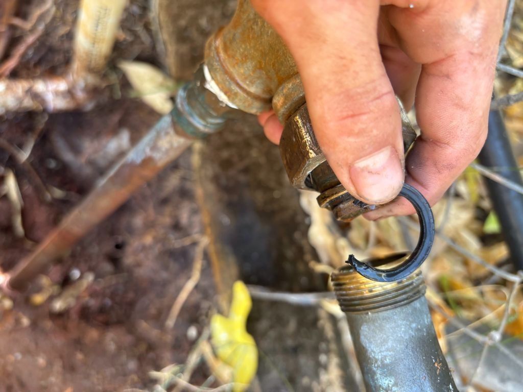 A Person is Holding a Metal Pipe in Their Hand — Nightcliff Plumbing & Gas In Casuarina, NT