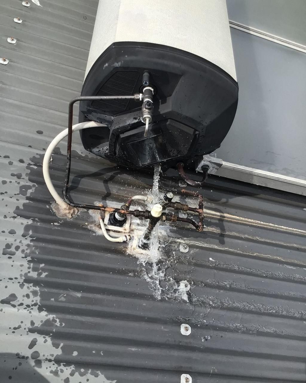 A Water Heater is Sitting on the Roof of a Building — Nightcliff Plumbing & Gas In Coconut Grove, NT