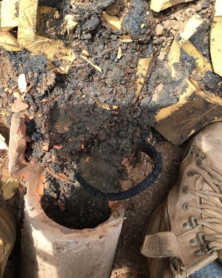 A Pair of Boots Sitting on Top of a Pile of Dirt — Nightcliff Plumbing & Gas In Casuarina, NT